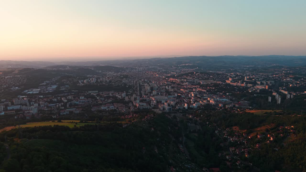 aerial shot of Saint Etienne city from Le guizay viewpoint at sunset, Loire departement, Auvergne Rhone Alpes region, France