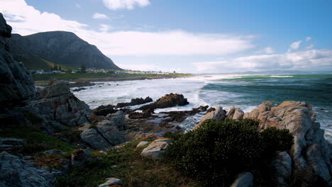 waves crash onto rocky coastline of hermanus in windy conditions, overstrand