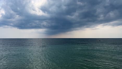 stormy sky and clouds over calm sea with