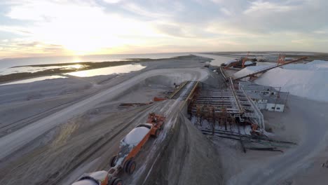 Aerial-shot-of-a-large-truck-before-unloading-the-salt-salt-in-the-salt-flats-by-solar-evaporation-in-Guerrero-Negro,-Ojo-de-Liebre-lagoon,-Biosphere-Reserve-of-El-Vizcaino,-Baja-California-Sur