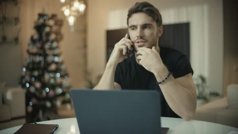 business man working at home at christmas holiday. entrepreneur talking phone