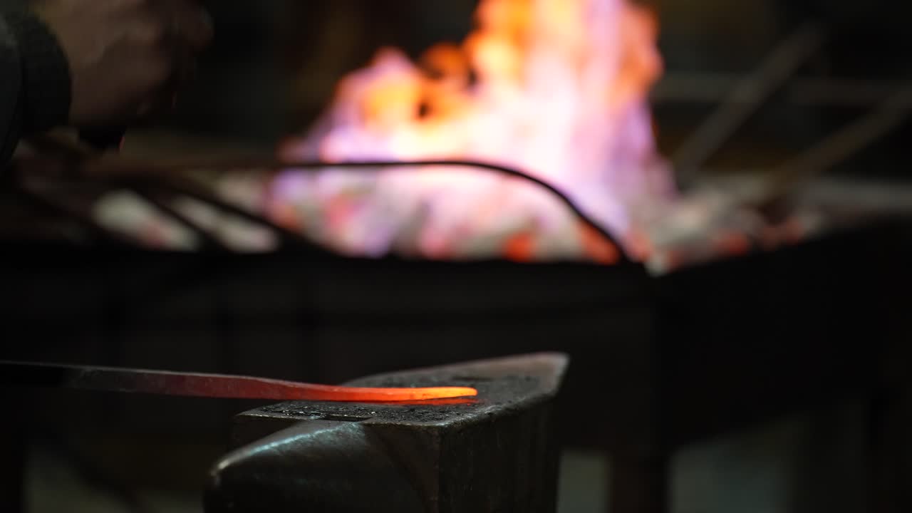 Hot Iron and Hammer on Anvil in Old Traditional Forge, Metal Takes Shape
