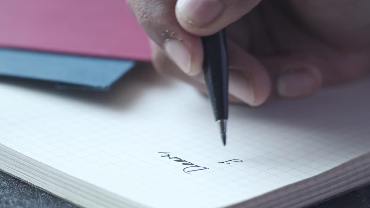 Person writing notes in a notebook