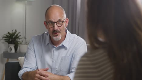 Mature-Man-Sitting-On-Sofa-Talking-With-Female-Counsellor-About-General-Or-Mental-Health-Issue-4