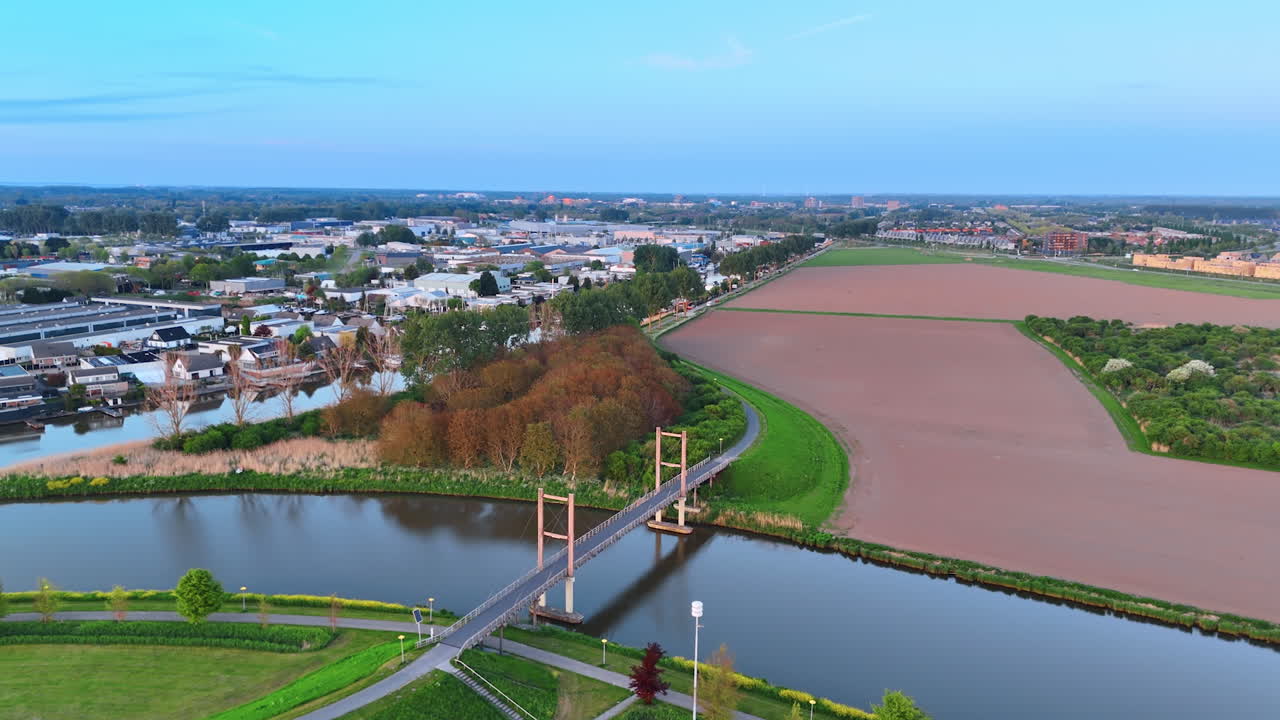 Beautiful cozy countryside on the canals in the Netherlands. Drone flight over the lovely urban area at sunset.