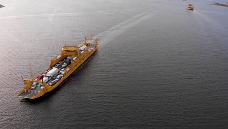 Drone-aerial-flight-with-view-of-car-ferries-driving-on-water-in-Gothenburg's-northern-archipelago-in-Sweden