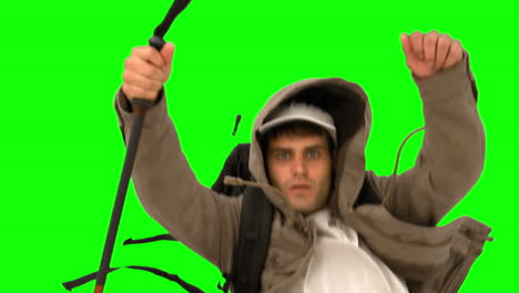 man with a hiking stick running on green screen