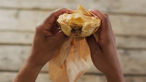 video of pie in hands on wooden worktop seeing from above