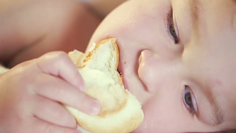 close-up of a child eating bun