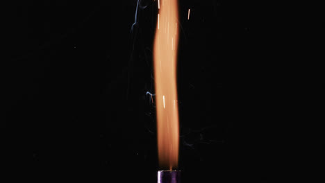 Video-of-torch-with-yellow-flame-and-sparks-and-copy-space-on-black-background