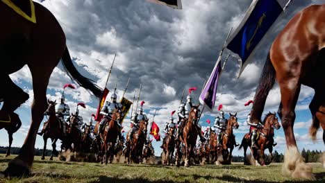 dramatic low-angle video shot of knights on horseback charging under a cloudy sky, capturing dynamic