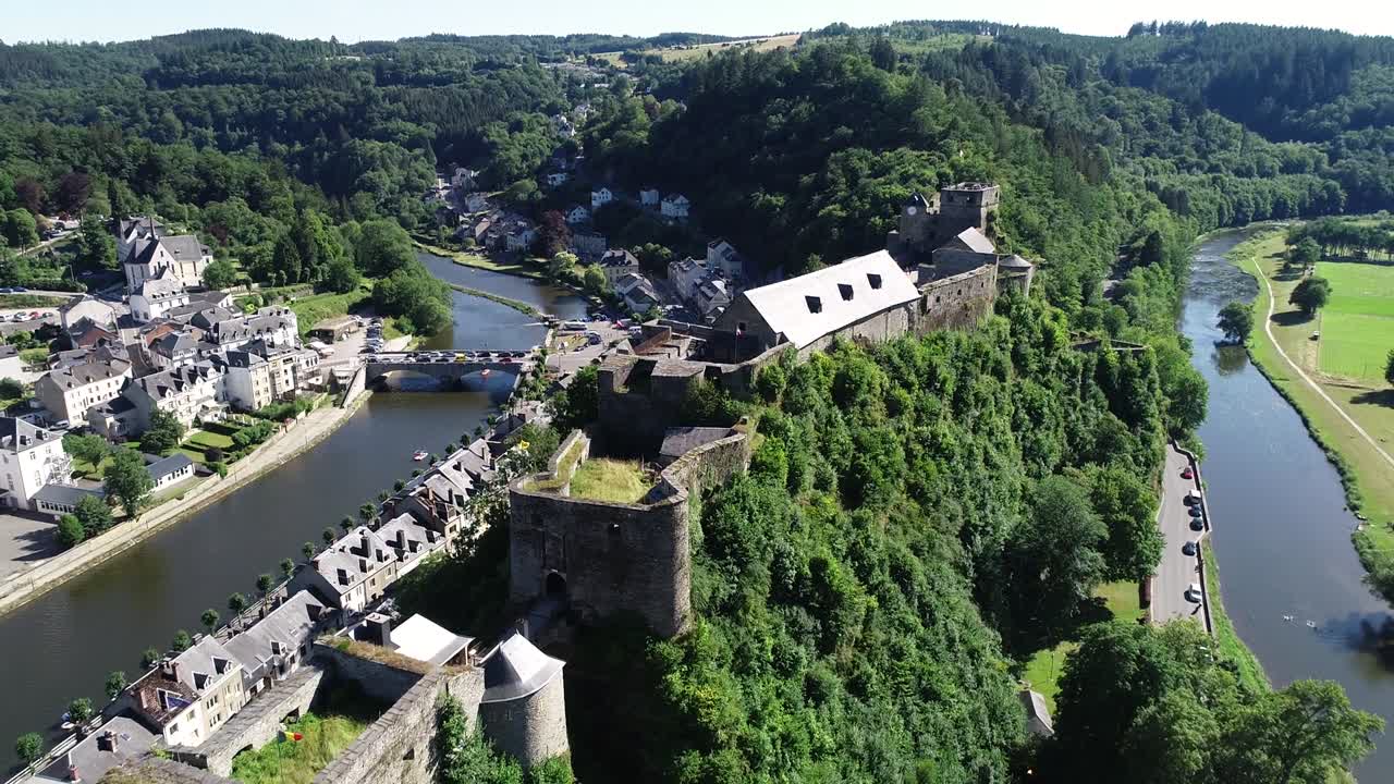 Aerial view of Bouillon Castle, medieval castle in the town of Bouillon in the province of Luxembourg, Belgium, Europe. Sunny summer day, beautiful green scenery.