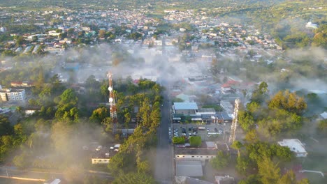 jarabacoa aerial view, city covered with fog in the morning, stunning environment of a small town in the dominican republic with trees and mountains behind the city