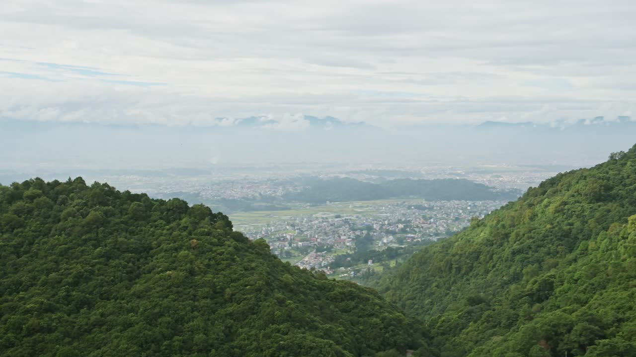 Kathmandu Valley and Himalayas Mountains Scenery, Forest Landscape in the Foothills and Kathmandu Cityscape with the City Behind