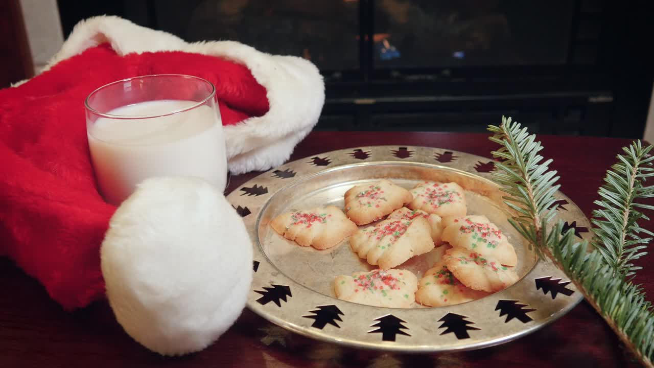 Christmas Still Life of Santa Hat with Plate of Milk and Cookies in 4k