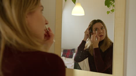 Girl-doing-makeup-on-herself-at-home