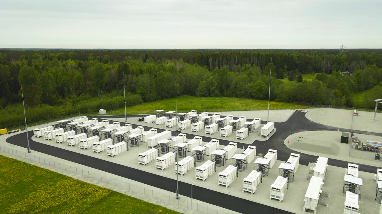Aerial perspective of a large scale BESS facility with rows of battery containers, crucial for storing renewable energy and grid stabilization