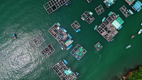 overhead view over the fishing boats and rafts of the fish farms on ma wan island, hong kong, china