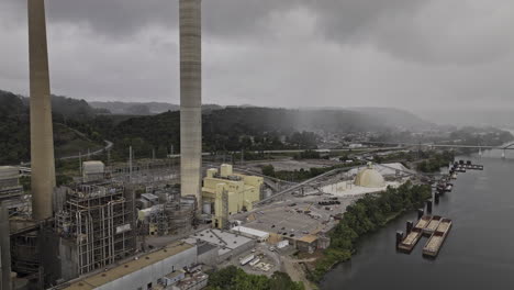 brilliant ohio aerial v9 flyover a large industrial facility, a power plant with towering smokestacks, situated alongside a river under an overcast sky - shot with mavic 3 pro cine - september 2023