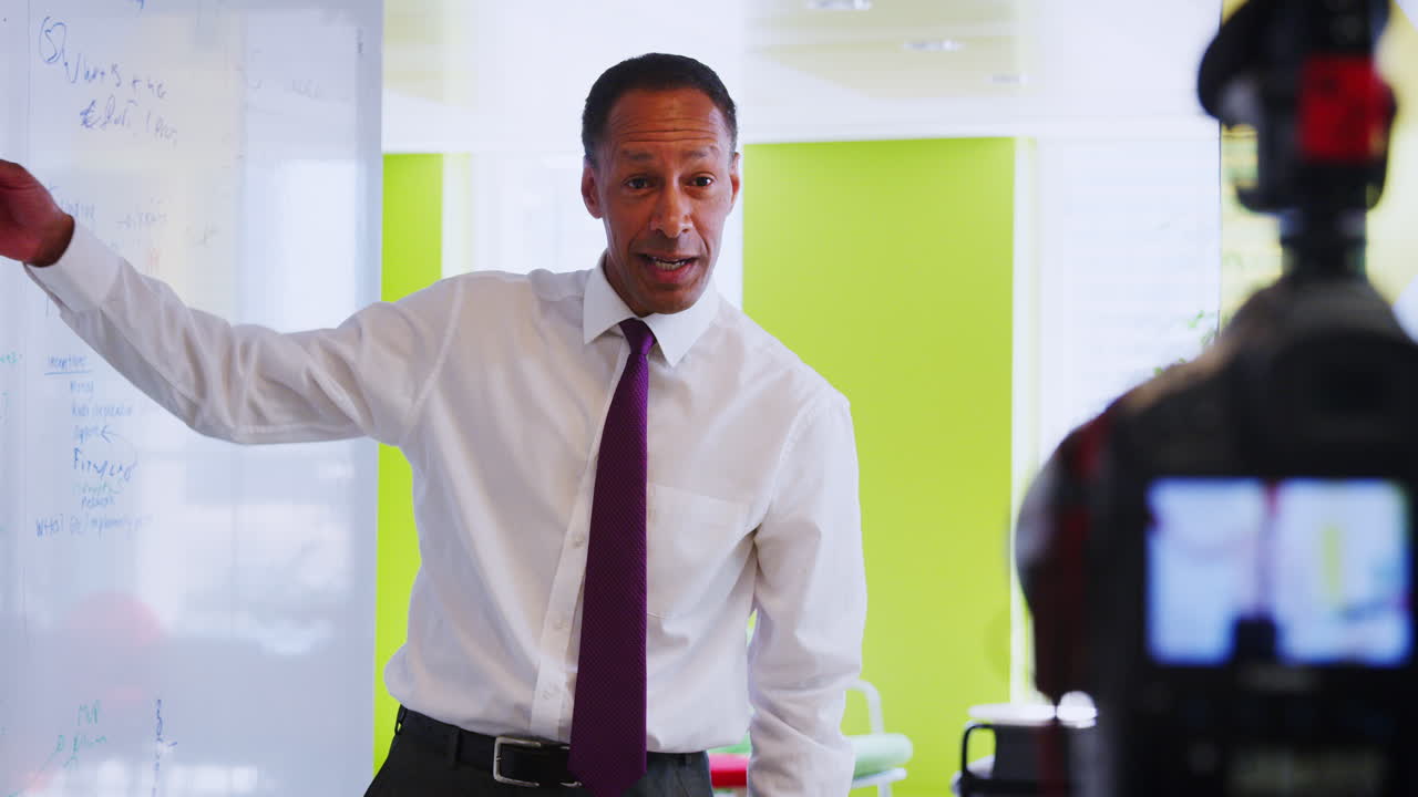 Middle aged black businessman making an instructional video