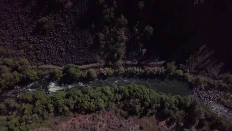 Flying-down-towards-river-at-the-bottom-of-a-canyon-in-Northen-California-Lassen-County