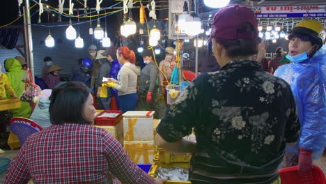 fisherman trading fresh fish in tho quang fishing port, vietnam