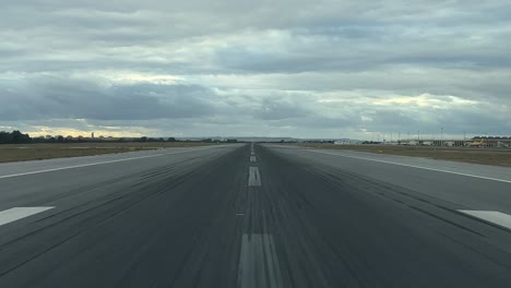 real-time take-off as seen by the pilots from a jet cockpit with a cloudy autumn sky