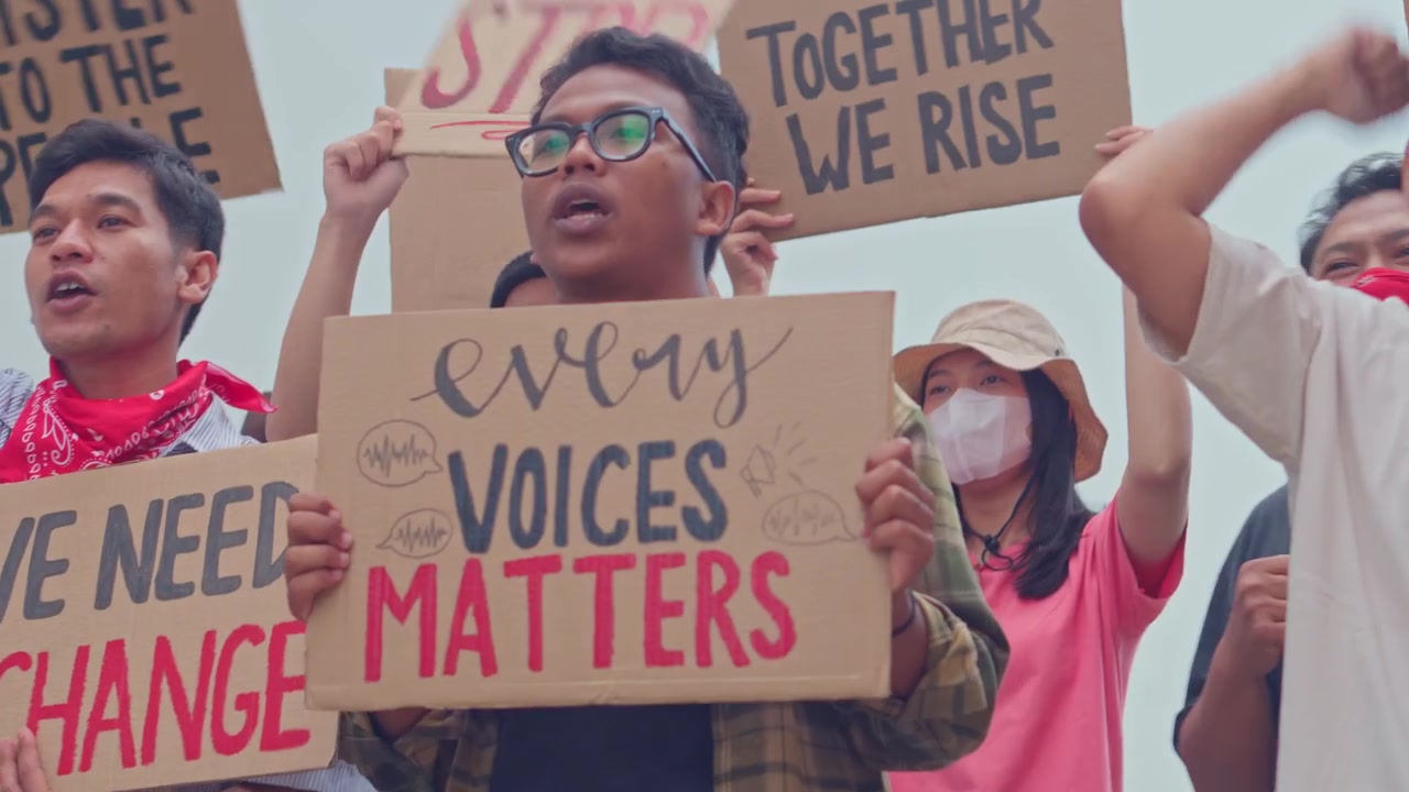 Passionate demonstrators raising placards with messages participating in vocal rally