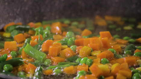 Extreme-Close-up-shot-on-Mix-of-Fresh-Vegetables-dropped-into-water-with-colorful-combination-with-a-black-background-and-shot-on-4K