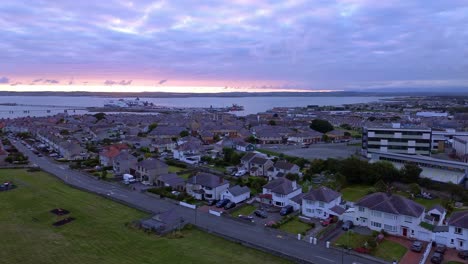 early morning aerial view circling above holyhead coastal suburban town sunrise during blue hour