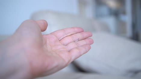 a woman holding a cat's claw that was found in the house