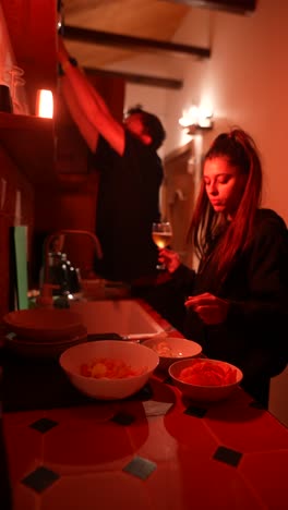 couple cooking and eating dinner in a kitchen