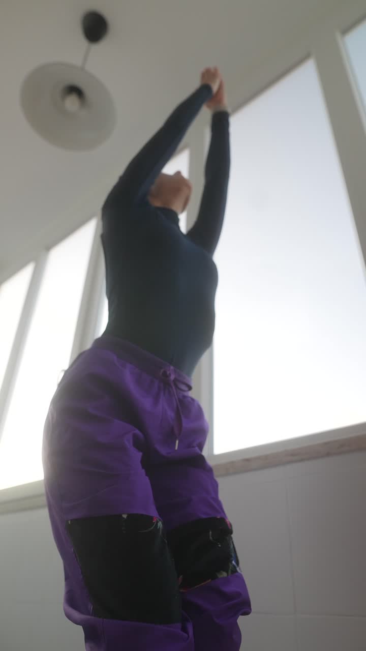 Woman practicing yoga poses indoors