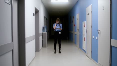 woman in uniform walking on the hallway