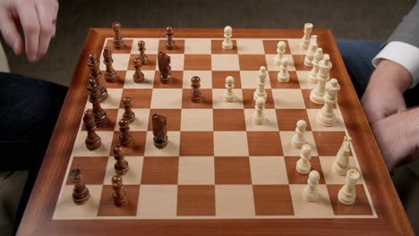 Chess-Game-Moves,-Two-Men-Moving-Pieces-With-View-Of-Whole-Board,-Slow-Motion