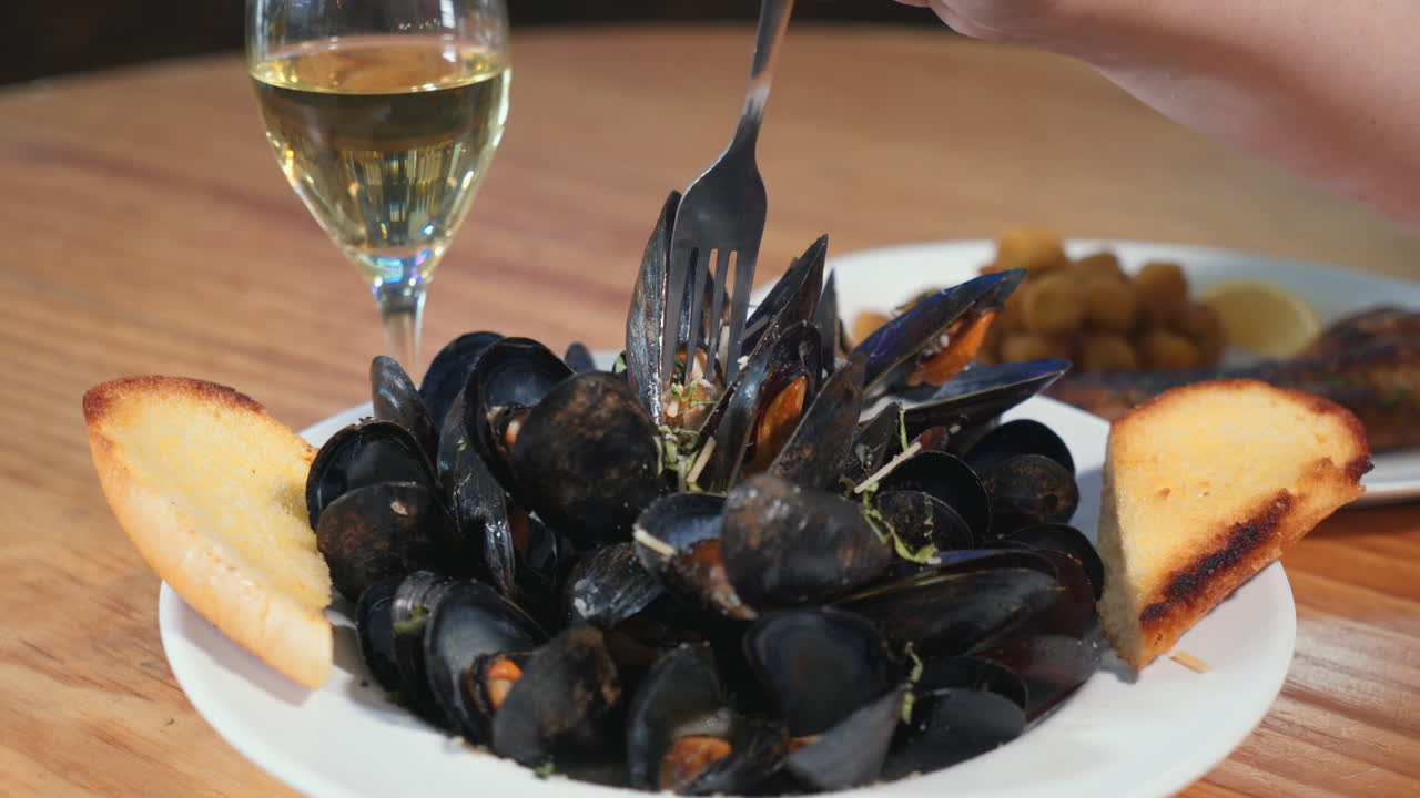 포크는 부드러운 찐 홍합을 집고, 포크는 껍질에서 홍합을 쉽게 제거하고, 슬라이더 hd