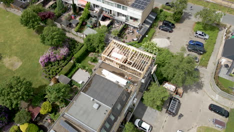 aerial of wooden frame of roof structure under construction in a suburban neighborhood