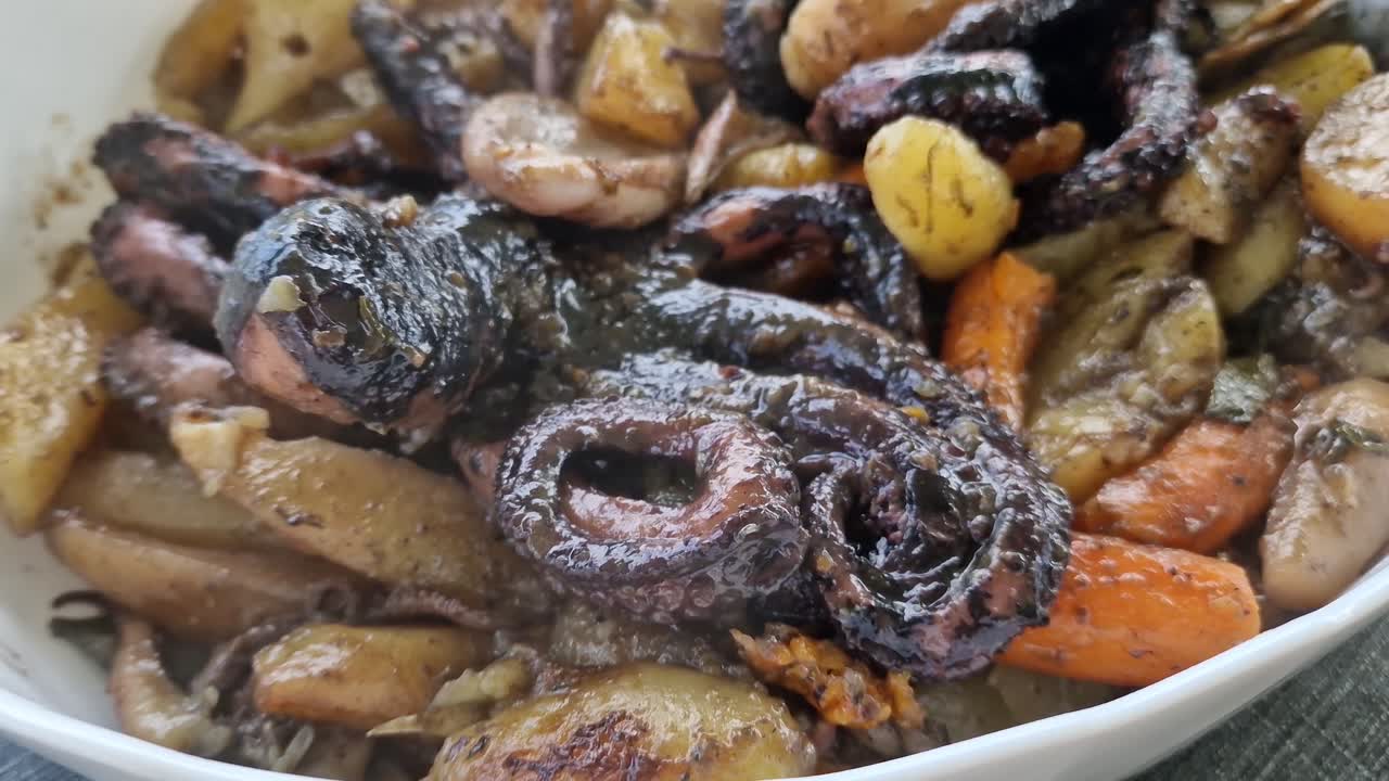 Octopus under the bell served in a restaurant. Typical traditional popular Dalmatian fish food. Close up