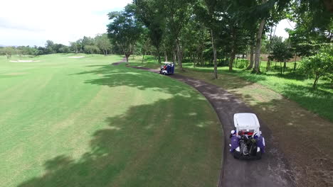 aerial of golf carts running in sta