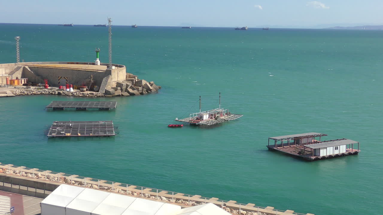 There are several fish farms in a harbor basin