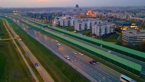 Hyperlapse-or-Dronelapse-Aerial-view-of-Highway-road-next-to-City-Warsaw,-Wilanow