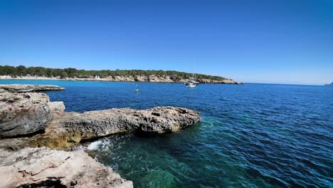 view from rocky shore of cala bassa beach in ibiza