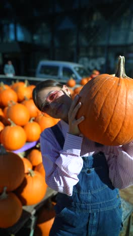 woman holding a large pumpkin