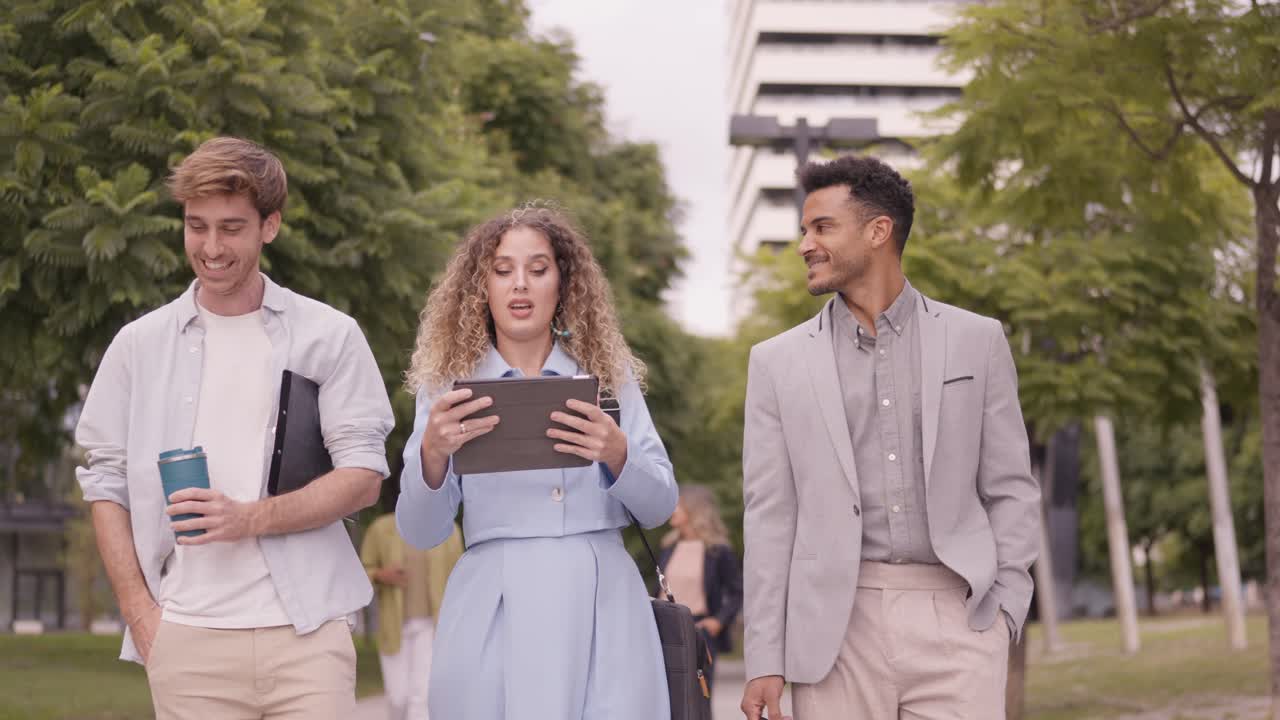 Business people walking and talking in park