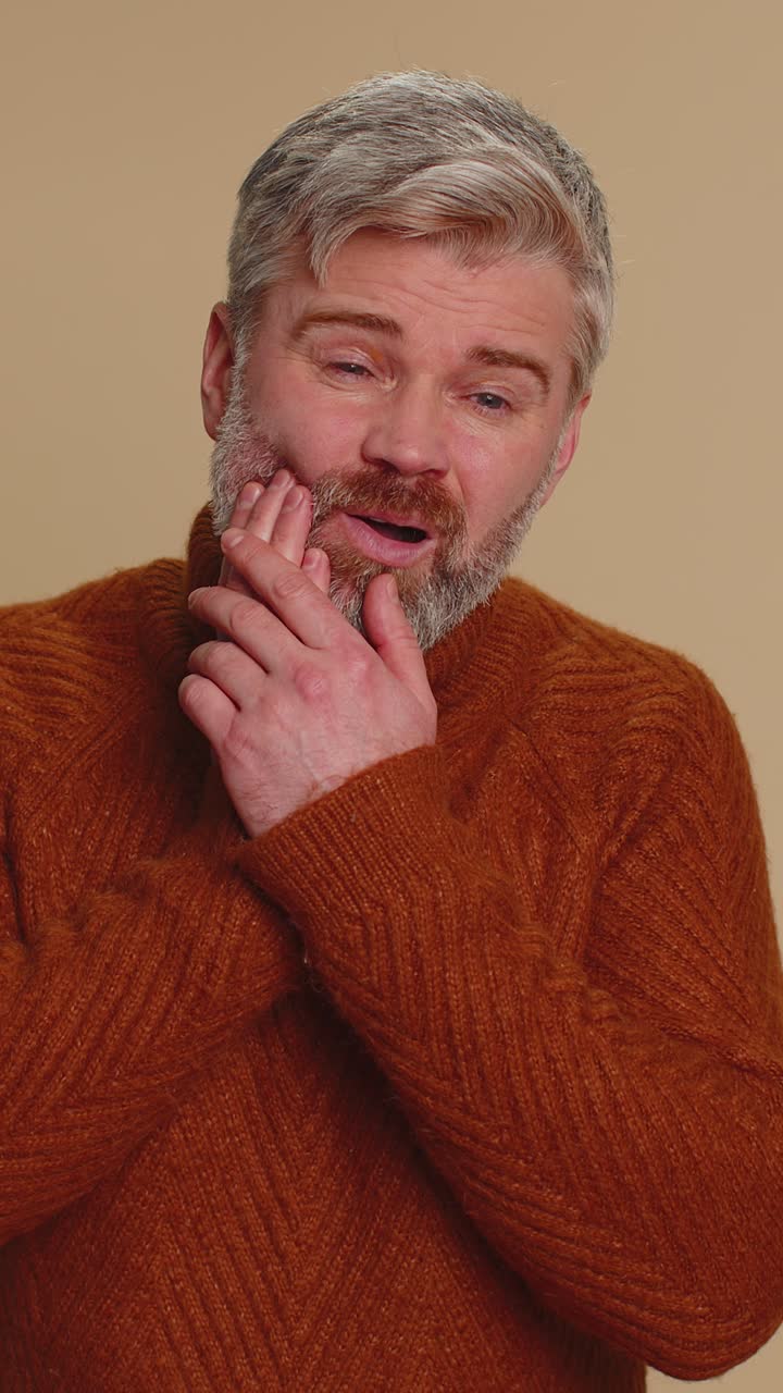 Man touching cheek suffering from toothache cavities or gingivitis waiting for dentist appointment