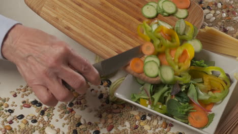 preparing vegan vegetarian lunch meal, mixed vegetable salad in white dish