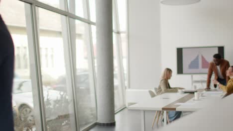 young entrepreneurs walking together and using digital tablet in the modern office