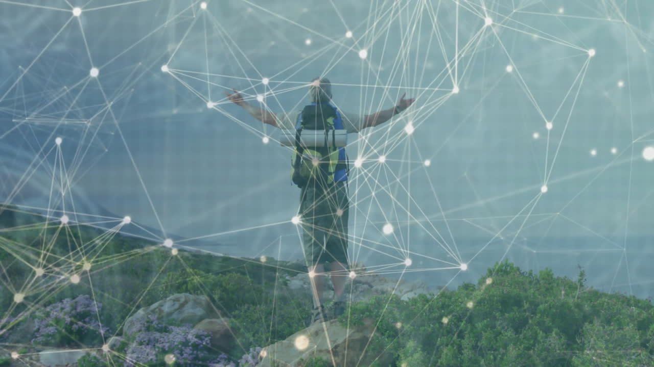 Hiker with backpack standing on rocky coast facing misty sea, showing glowing technology overlay