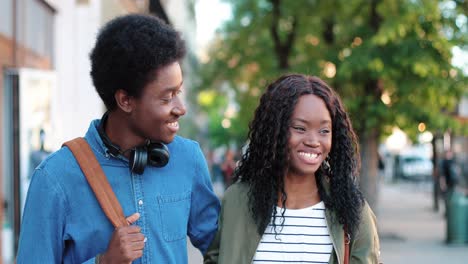 close-up view of african american couple talking and walking down the street