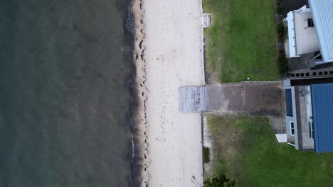 Vogelperspektiveaufnahme-Des-Sonnenaufgangsstrandes-Mit-Einem-Mädchen,-Das-Am-Strand-Entlang-Läuft